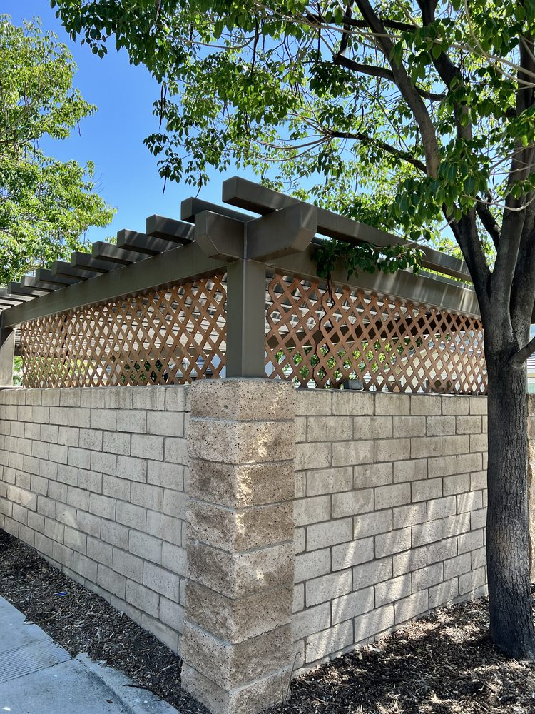 Lattice and pergola fence topper above a block wall