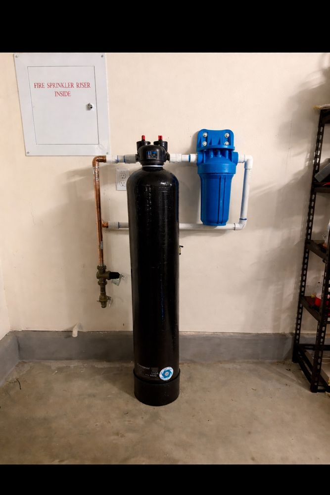 Whole-house water filtration system installed in garage